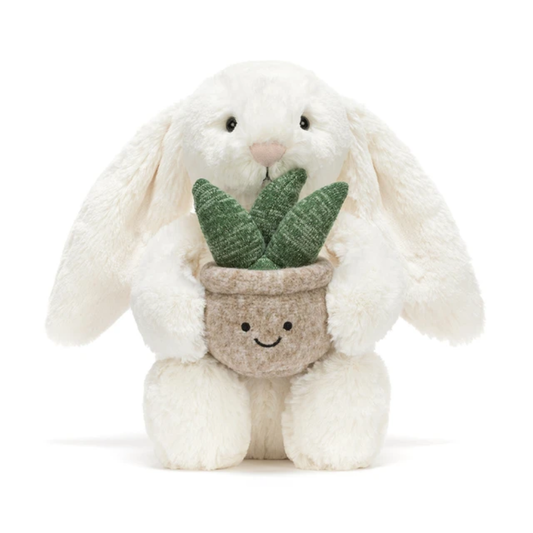 Cream bunny plush toy holding a plant