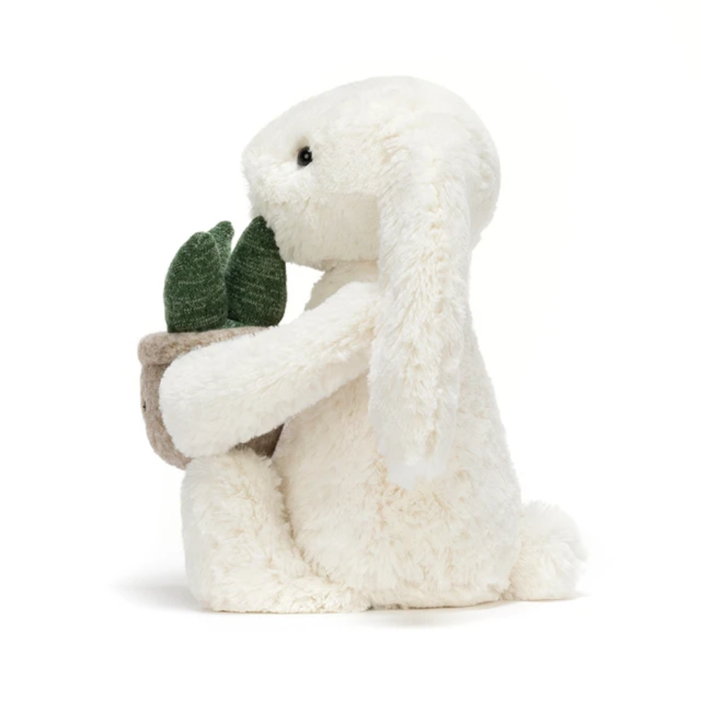 Cream bunny plush toy holding a plant – view 3